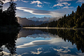 Lake Matheson at sunrise with Mount Cook on right center and Mount Tasman on left center,South Island,New Zealand