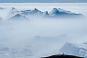 Lone person overlooks icebergs at the Ilulissat Icefjord,Ilulissat,Greenland