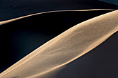 Afternoon light casts long shadows on sand dunes in Namib-Naukluft Park,Sossusvlei,Namibia