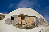 Close-up of domed,Cave House against a bright blue sky in the town of Goreme in Pigeon Valley,Cappadocia Region,Nevsehir Province,Turkey