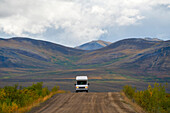 Small recreational vehicle driving the Dempster Highway,Dawson City,Yukon,Canada