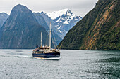 Tourist boat at Fiordland National Park,Milford Sound,South Island,New Zealand