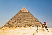 Touristen reiten auf einem Kamel, Chephren-Pyramide, Pyramidenkomplex von Gizeh, UNESCO-Weltkulturerbe, Gizeh, Ägypten