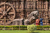 Young family taking a self-portrait near a statue of a lion at Konark Sun Temple,Odisha State,India