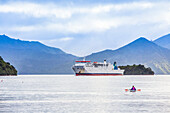 Kayaks float in the harbor as the Inter-island Ferry comes into port of Picton on the South Island of New Zealand,Picton,Marlborough,New Zealand