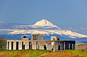 Replica of Stonehenge at the Maryhill Museum of Art in the foreground with a snow-capped Mount Hood in the background,Washington,United States of America