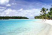 Palm trees line the shore of islands with clear turquoise water and bright blue sky,Cook Islands