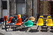 Colorful plastic chairs on the sidewalk at an outdoor flea market.,Paris,France