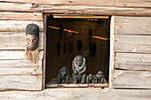 The side of a home and its windowsill are decorated with handmade traditional wooden sculptures.,Bwindi Impenetrable National Park,Uganda