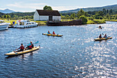 Several couples kayak in the Caledonian Canal near Fort Augustus,Scotland,Fort Augustus,Scotland