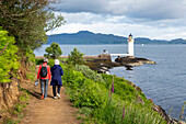 Two women hike towards Rubha nan Gall  (Stevenson) lighthouse near Tobermory,Scotland,Tobermory,Isle of Mull,Scotland