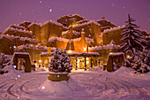 A snow topped inn is decorated for the winter holidays in Santa Fe.