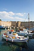 Fishing boats moored in Kolona Harbour in the medieval city of Rhodes,Greece,Rhodes,Dodecanese,Greece