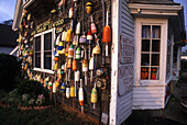 Colorful lobster pot floats adorning the wall of a seafood shack.,Rock Harbor,Massachusetts.