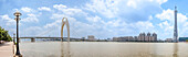 Thirteen original photographs were stitched together to create this panorama of the Liede Bridge and the Guangzhou TV & Sightseeing Tower,also known as Canton Tower,a 610 meter structure near Chigang Pagoda,Haizhu District,Guangzhou,Guangdong province,People's Republic of China. It was completed for the 2010 Asian Games,Guangzhou,Guangdong,China