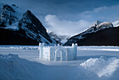 Ice castle on Lake Louise with mountains on far shore in Banff National Park,Alberta,Canada