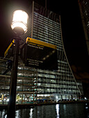 Mackenzie Walk sign with glass building and river Thames at night,Canary Wharf,London,UK,London,England