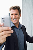 Businessman Taking Photo with Camera Phone