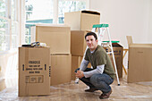 Man in Home with Cardboard Boxes