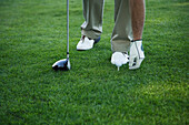 Golfer Placing Ball on Tee