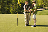 Male Golfers Shaking Hands