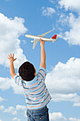 Boy Playing with Toy Airplane