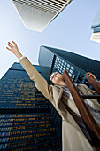 Businesswoman Standing on Ladder Reaching Upwards