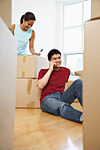 Woman Packing,Man on Cellular Phone