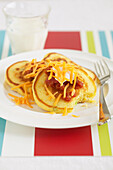 Pancakes on Plate with Cheese and Sour Cream