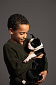 Little Boy Holding Dog
