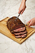 Hands Carving Roast Beef