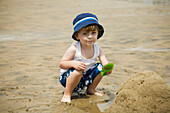 Portrait of Boy Playing in Sand on Beach