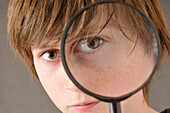 Boy Looking through Magnifying Glass