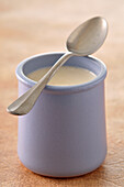 Close-up of Spoon Balanced on Mug of Yogurt