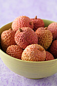 Close-up of Lychees in Bowl on Purple Background with Selective Focus