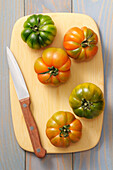 Overhead View of Tomatoes on cutting Board with Knife,Studio Shot