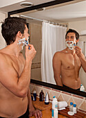 Man Shaving in Hotel Room,Reef Playacar Resort and Spa,Playa del Carmen,Mexico