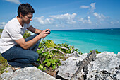 Man Taking Picture of Iguana,Reef Playacar Resort and Spa,Playa del Carmen,Mexico