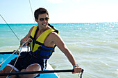 Man Sailboating,Reef Playacar Resort and Spa Hotel,Playa del Carmen,Quintana Roo,Yucatan Peninsula,Mexico
