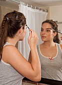 Woman Applying Make-up in Bathroom,Reef Playacar Resort and Spa,Playa del Carmen,Mexico