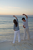 Couple Exercising on Beach,Reef Playacar Resort and Spa,Playa del Carmen,Mexico