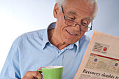 Man Drinking Coffee and Reading Newspaper