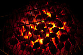 Close-up of hot charcoals glowing from underneath barbeque grill,Germany