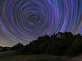 Concentric star trail over a medieval castle in the Italian countryside,Emilia Romagna,Italy,Europe