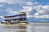 Traditional wooden boat navigating on the Rio Negro,Manaus,Amazonia State,Brazil,South America