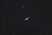 Comet C/2022 E3 (ZTF) on the night of January 22/23,2023 when it was in Draco,with it near the reddish star Edasich (aka Iota Draconis) at top,and the edge-on galaxy NGC 5907 below the comet. To the right of that galaxy is NGC 5866,aka M102. The dust tail of the comet was showing a strong anti-tail spike ahead of the comet's greenish coma,as this was two days before we crossed the plane of the comet's orbit when we would see its dust tail "edge-on." The coma of the comet is strongly cyan or green from glowing diatomic carbon molecules,common for comets. There was little sign of the blue ion ta