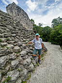 A tourist on Structure 1 of the Maler Group or Plaza of the Shadows in the Mayan ruins in Yaxha-Nakun-Naranjo National Park,Guatemala.