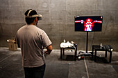 Young man playing with Meta Quest 2 all-in-one VR headset during ZGamer,a festival of video games,digital entertainment,board games and YouTubers during El Pilar Fiestas in Zaragoza,Aragon,Spain