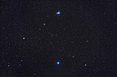This wide-field image frames the end stars of the Big Dipper's handle — Mizar at top,and Alkaid at bottom — and to also include in the frame the bright galaxies Messier 101 (at left) and Messier 51 (at lower right,aka the Whirlpool Galaxy). They are small on this image scale but the image serves for a finder chart illustration of the location of these galaxies relative to the Handle. The famous double star Mizar and Alcor is also obvious at top,as is the red giant star 83 Ursa Majoris. The field is 10° x 15°,so wider than binoculars.