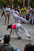 Members of Mestre Branco Capoeira Escola demonstrate in the street during the Fiestas of El Pilar in Zaragoza,Aragon,Spain